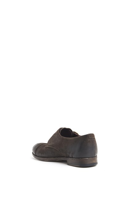 Leather worn out shoe with brass buckles