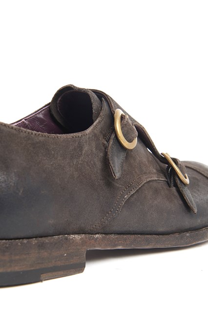 Leather worn out shoe with brass buckles