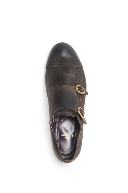 Leather worn out shoe with brass buckles
